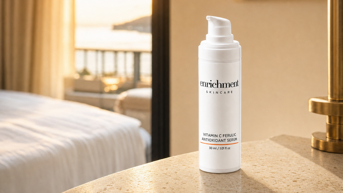 Enrichment Skincare Vitamin C Ferulic Antioxidant Serum on a stone bedside table in morning sunlight