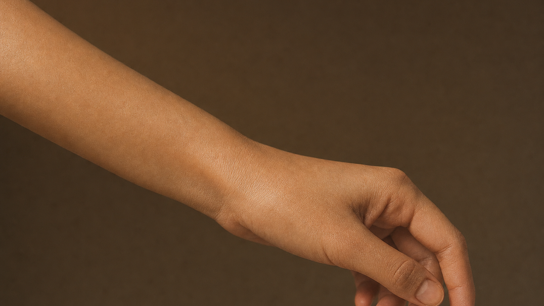 Close-up of a woman's forearm, wrist, and hand, showing soft natural skin texture