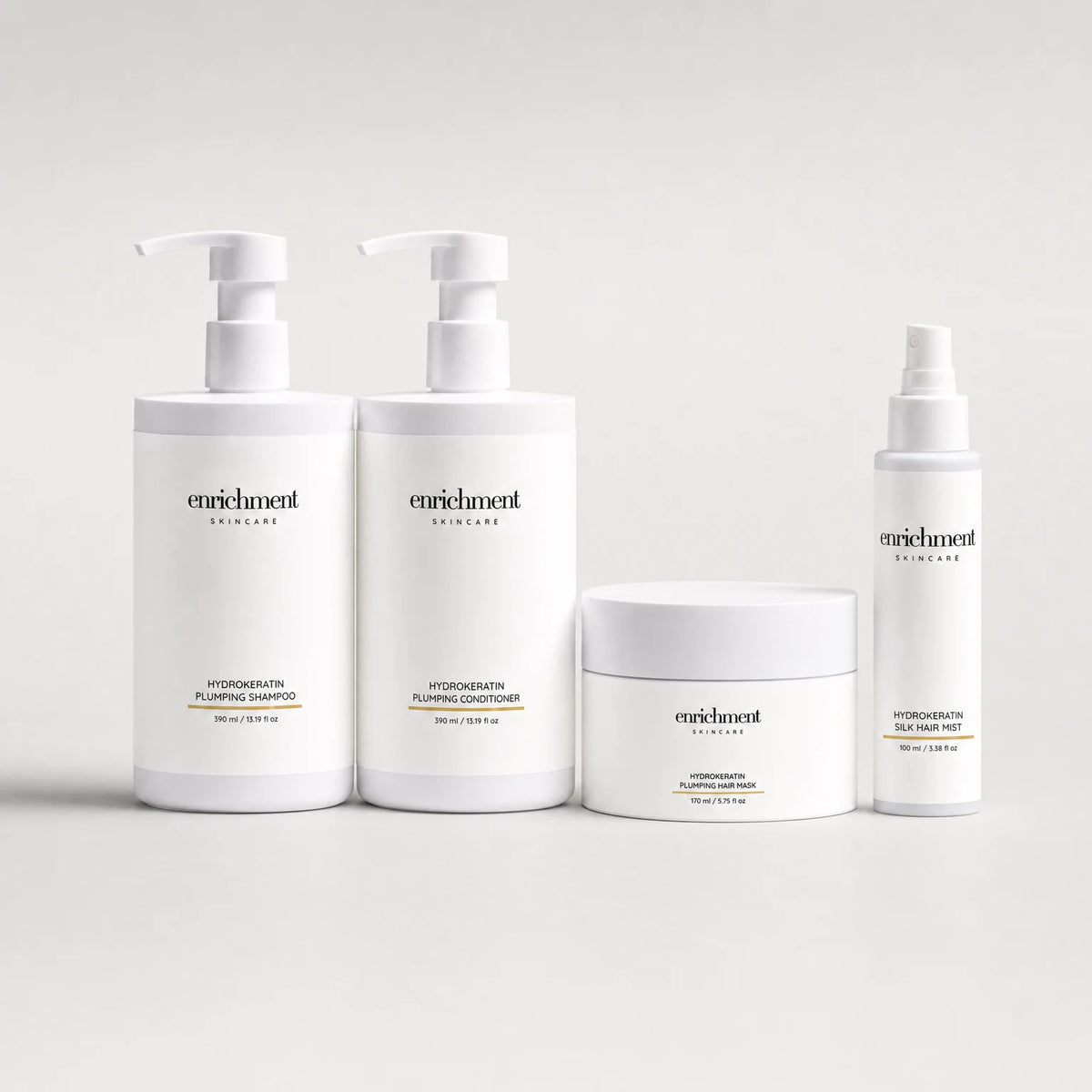 Four Enrichment Skincare hair products in a row: Hydrokeratin Plumping Shampoo, Hydrokeratin Plumping Conditioner, Hydrokeratin Plumping Hair Mask and Hydrokeratin Silk Hair Mist