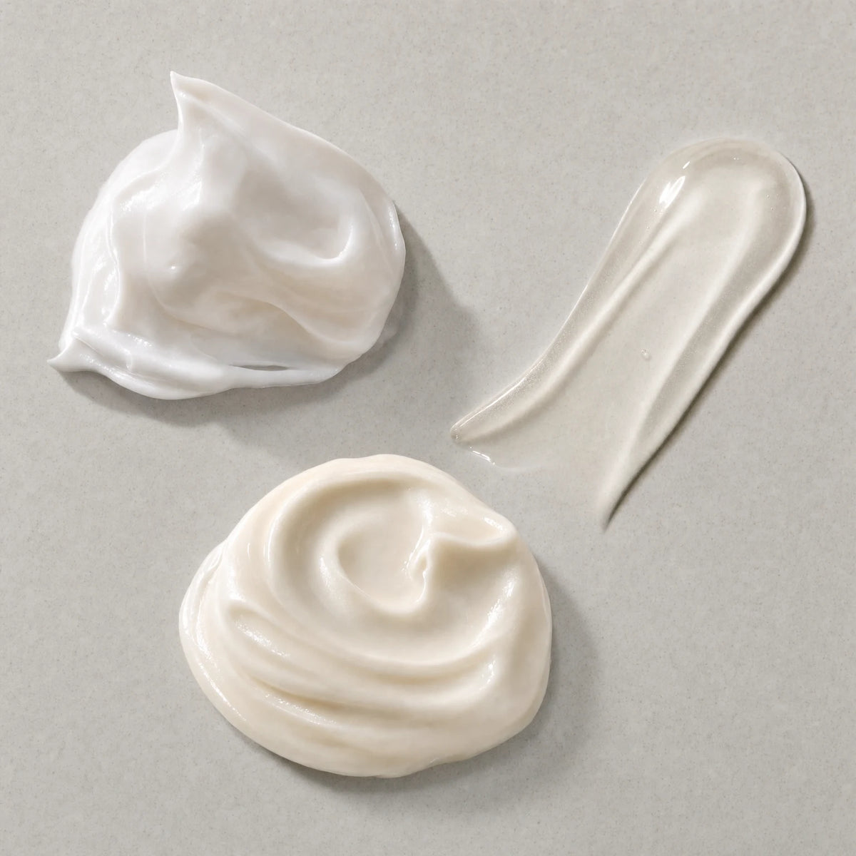 Swatches of the three formulas: white cream, clear serum and rich cream