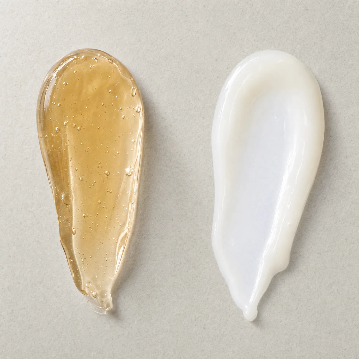 Swatches of the two formulas: a golden-amber serum gel and a milky white creamy serum
