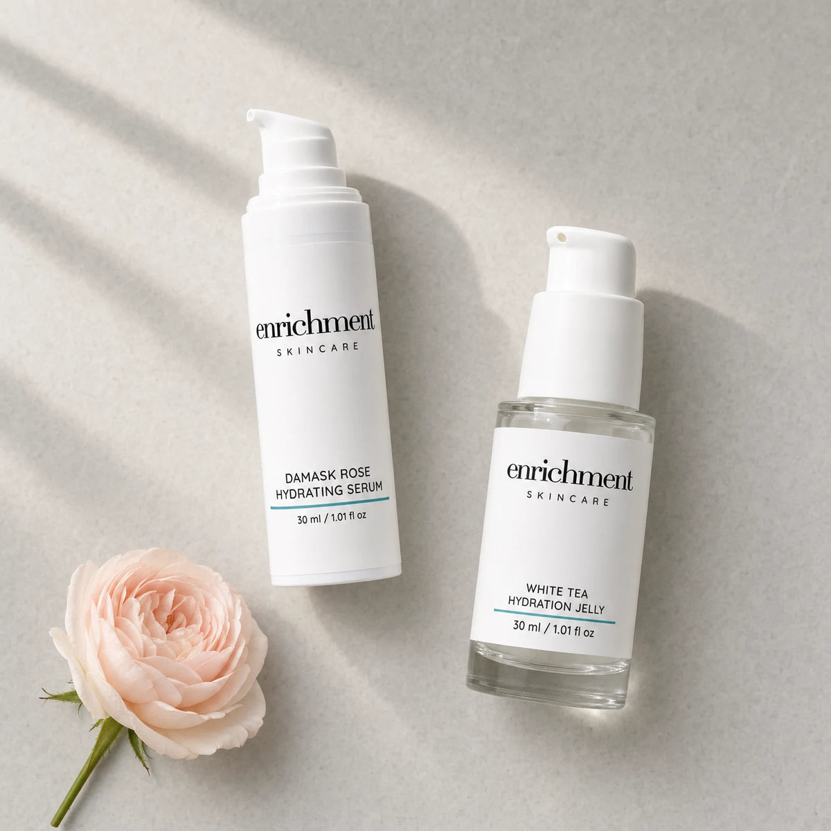 The two Duo products laid out in usage order, serum then jelly, with a single pale damask rose