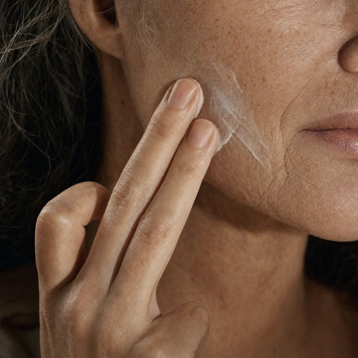 Applying Ceramide Cocoon Night Cream to the cheek