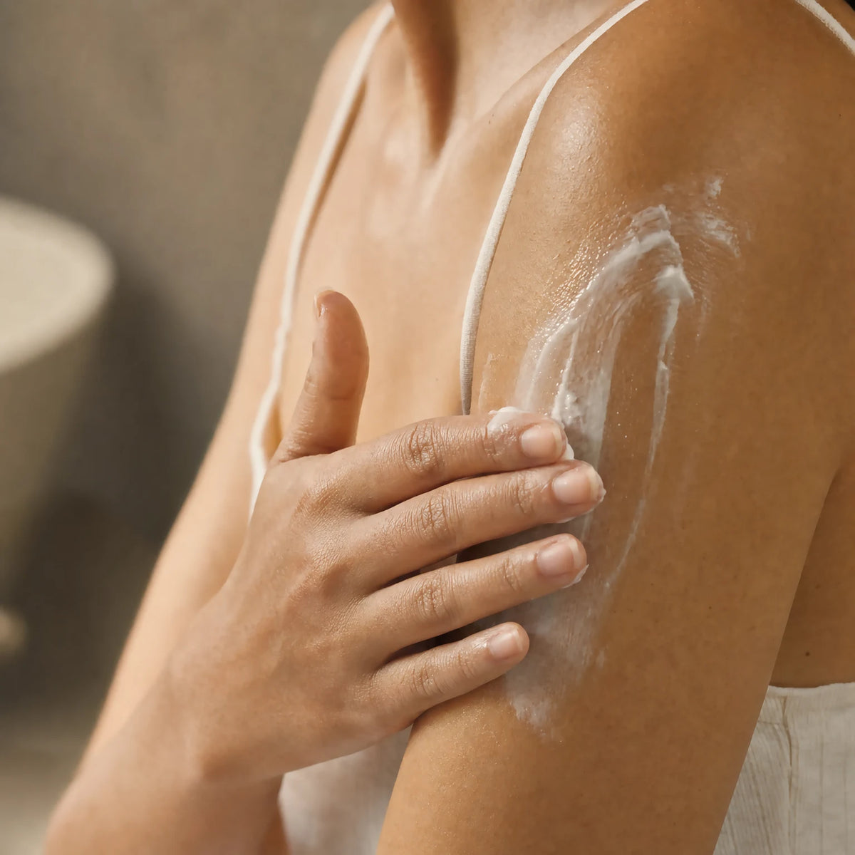 Hand smoothing Satin Smoothing Body Cream into the upper arm