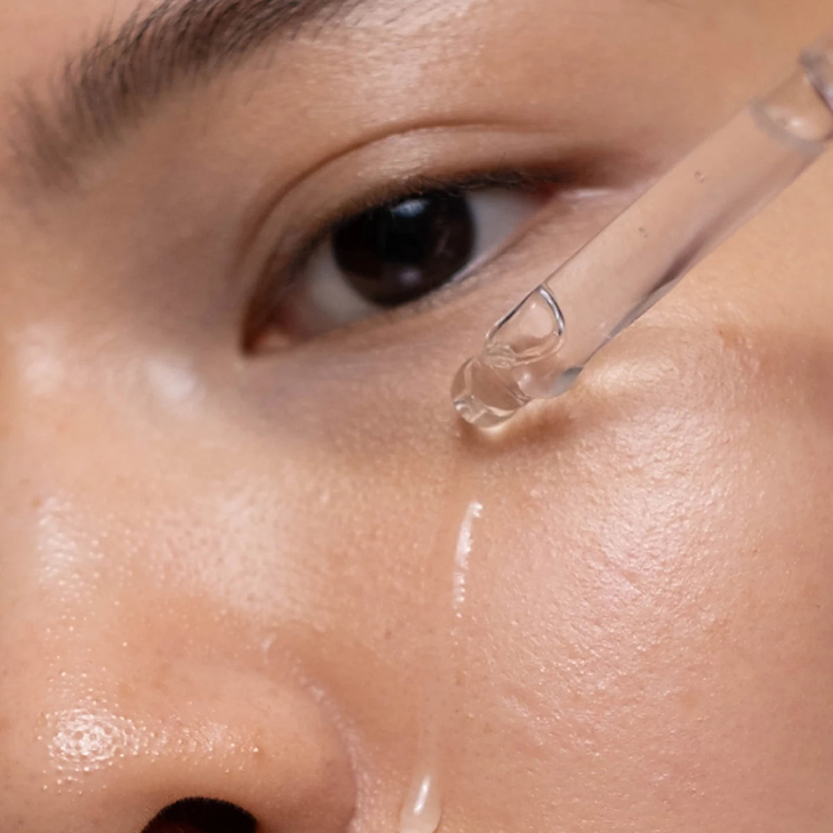 Applying Lactic Acid Overnight Concentrate with the dropper to the face