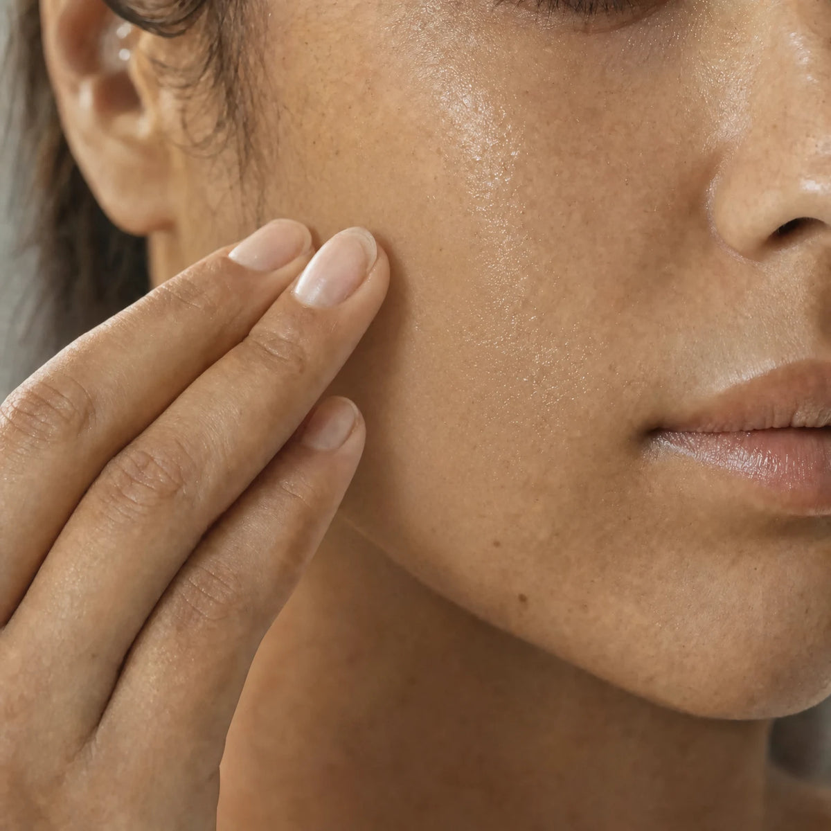 Applying Linden Flower Micellar Water by hand to the cheek