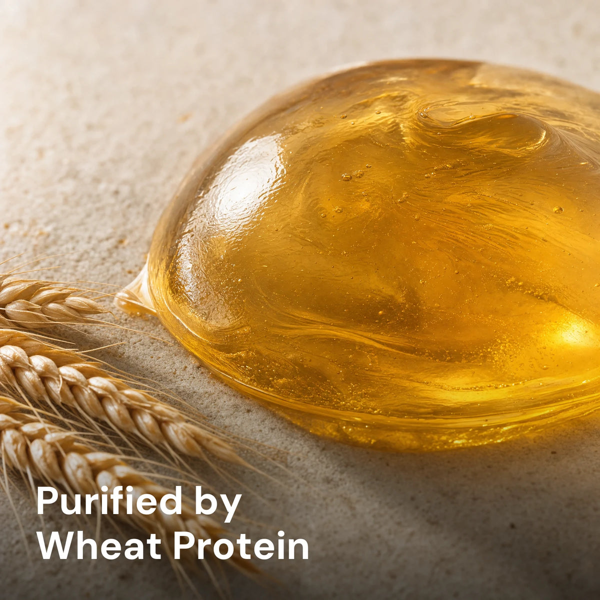 Glossy amber wheat protein droplet with a light wheat-spikelet accent