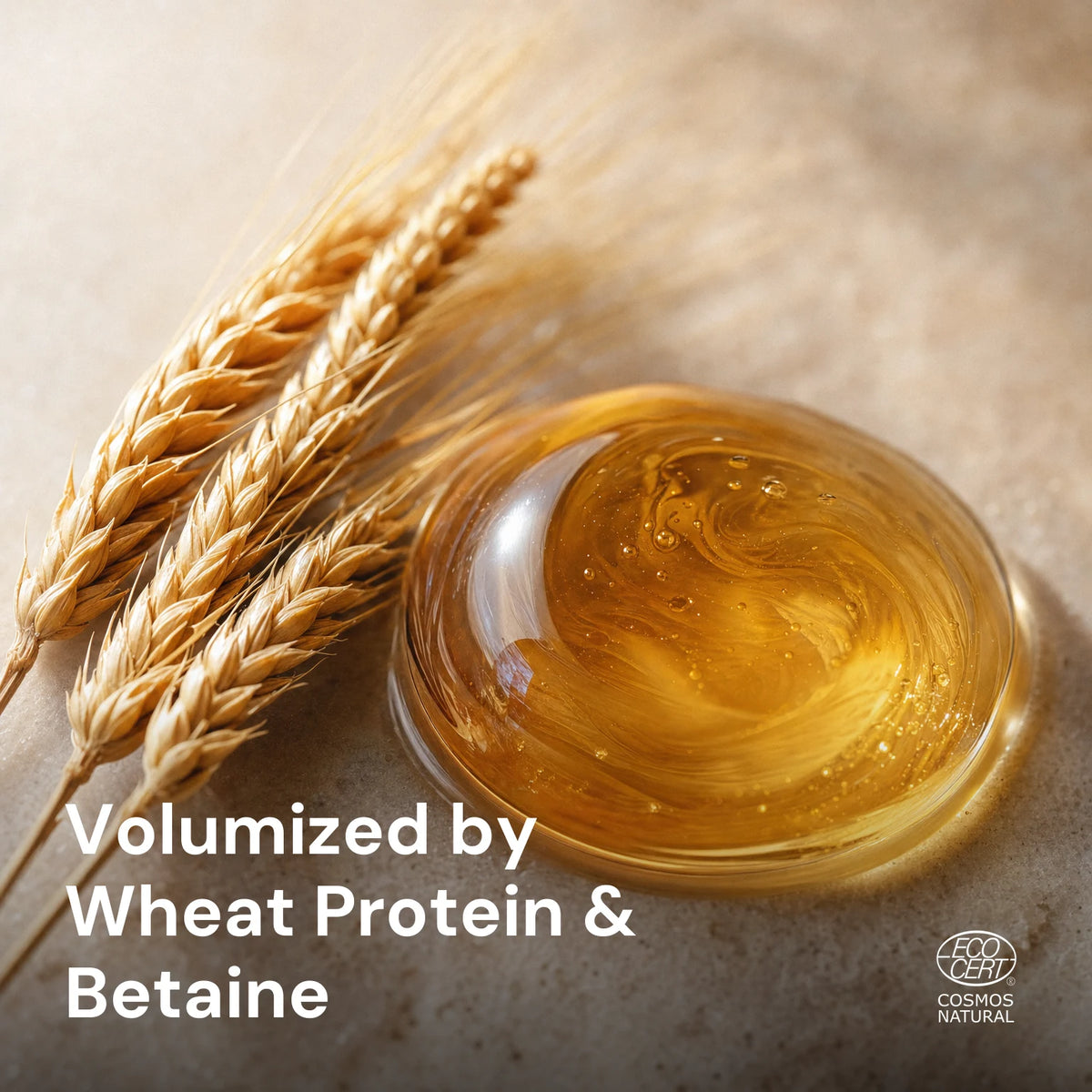 Glossy amber wheat protein droplet with a light wheat-spikelet accent