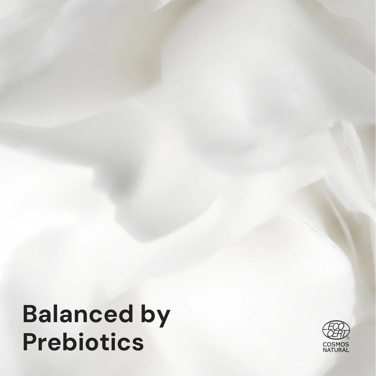 Close-up of soft white folds with the text Balanced by Prebiotics