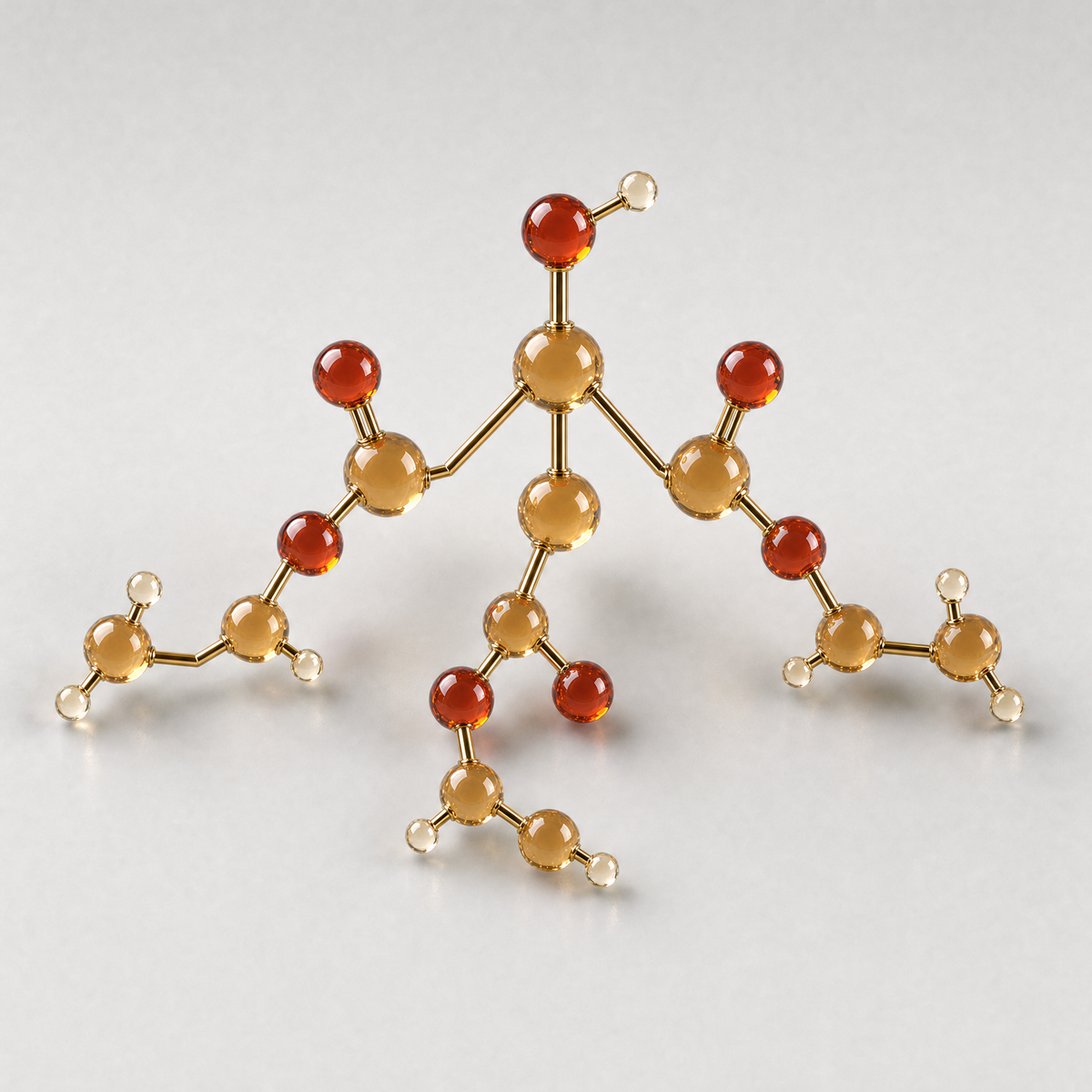A glass ball-and-stick model of a three-armed triethyl citrate molecule