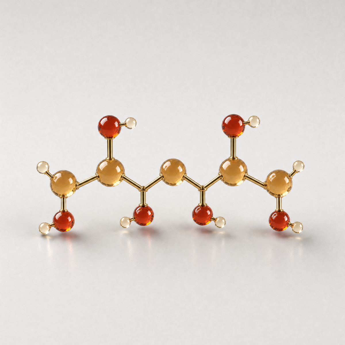 A glass ball-and-stick model of a xylitol molecule, a five-carbon chain with hydroxyl groups
