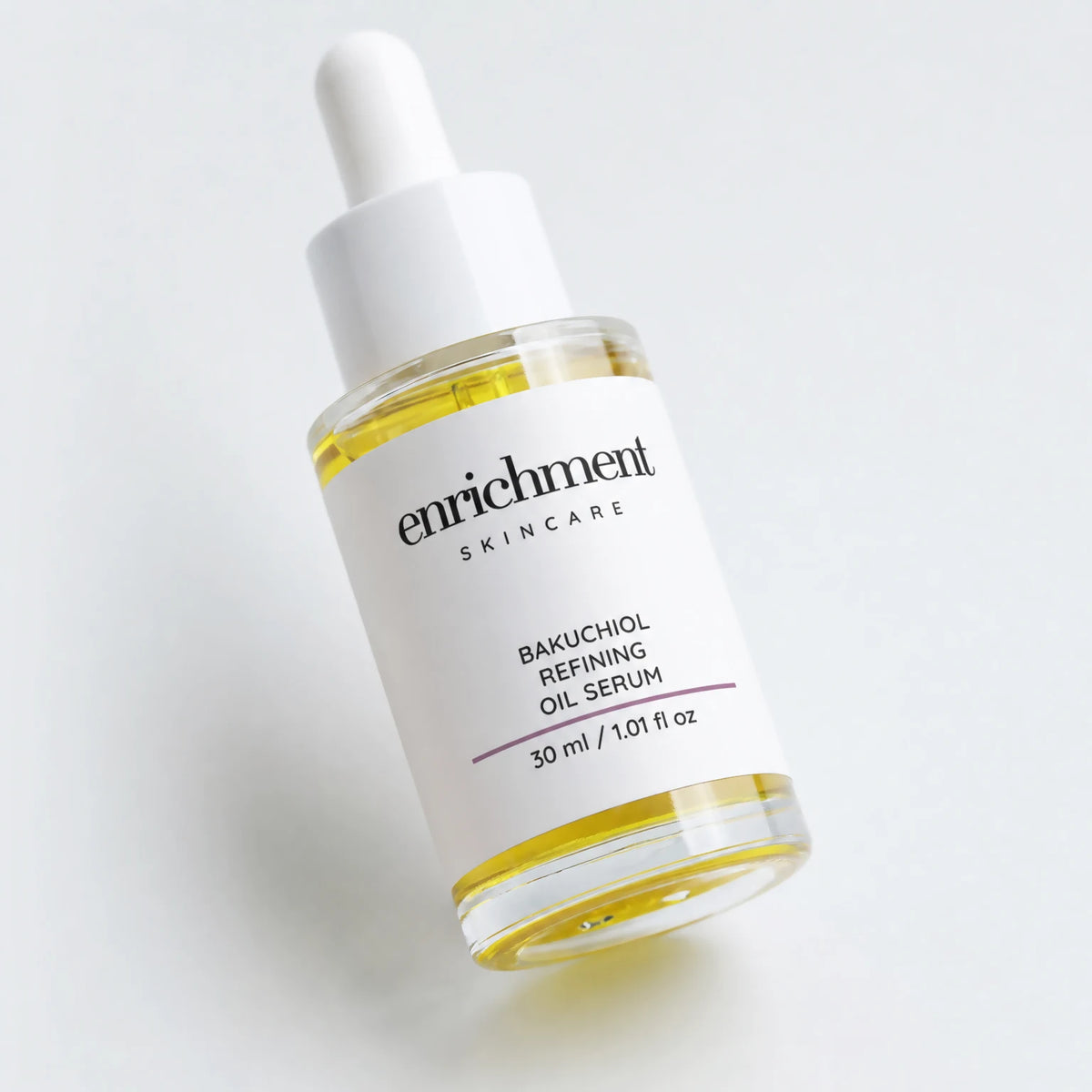 Enrichment Bakuchiol Refining Oil Serum bottle with the enrichment SKINCARE wordmark and 30 ml / 1.01 fl oz volume line centred on the label