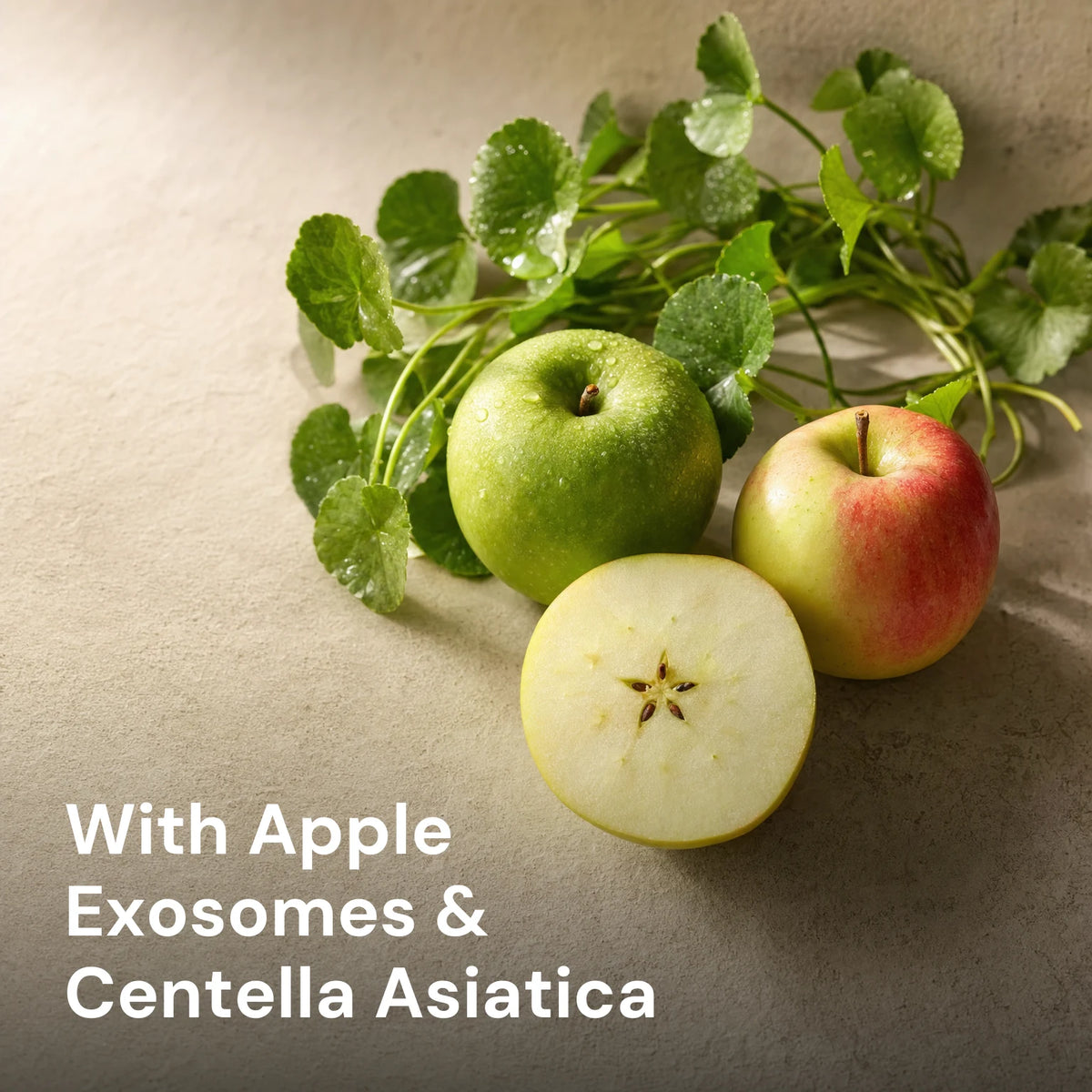 Fresh whole and halved apples with Centella asiatica leaves, captioned With Apple Exosomes & Centella Asiatica